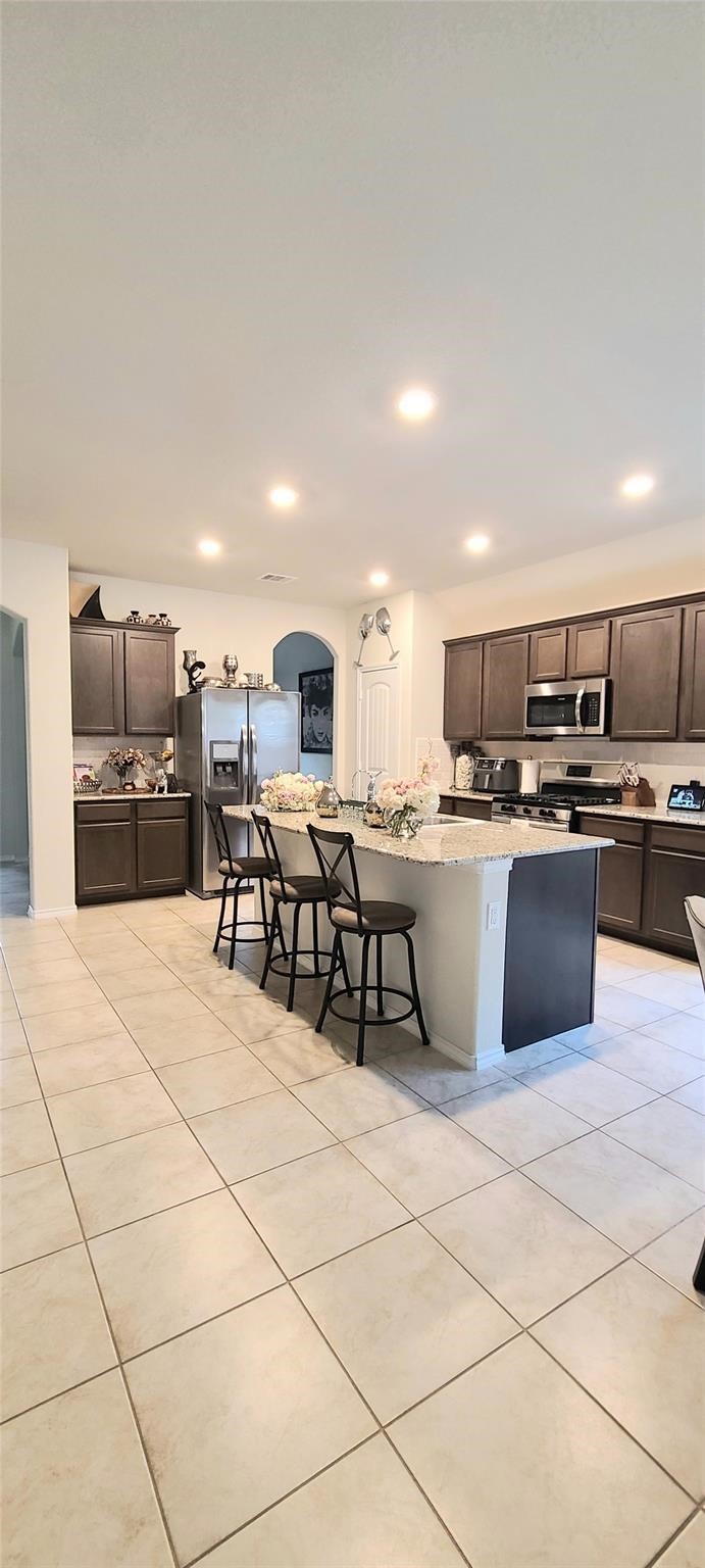 2710 Little Caney Way Conroe, TX 77301 - Photo 8 of 25 a kitchen with stainless steel appliances kitchen island granite countertop a sink and cabinets