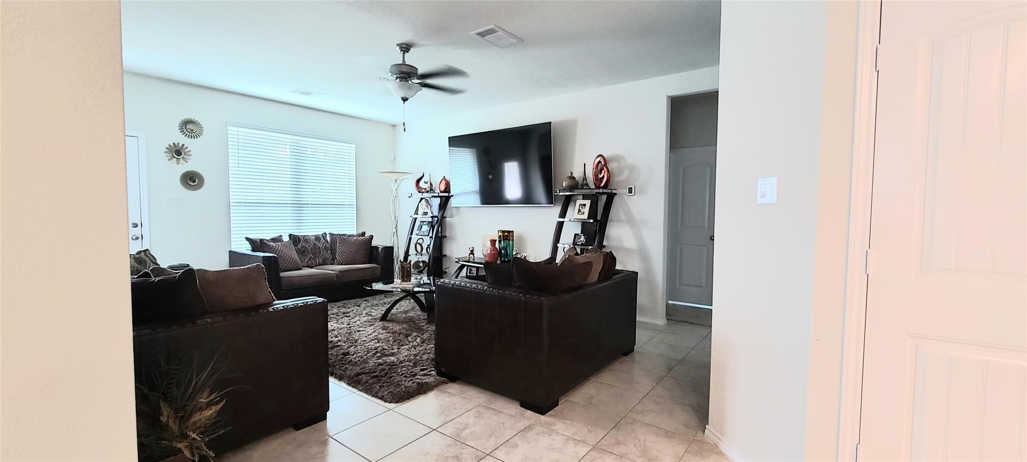 2710 Little Caney Way Conroe, TX 77301 - Photo 10 of 25 a living room with furniture and a flat screen tv