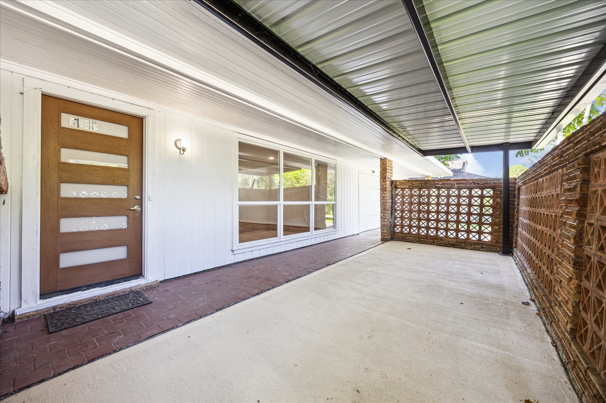 5419 Beechnut Street Houston, TX 77096 - Photo 3 of 28 Inviting front patio with stylish mid-century brick accents, large picture window, and modern front door creating a warm welcome.