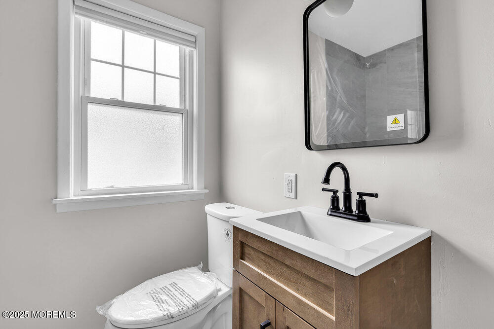 37 Knight Avenue Runnemede, NJ 08078 - Photo 16 of 50 a bathroom with a toilet sink and mirror