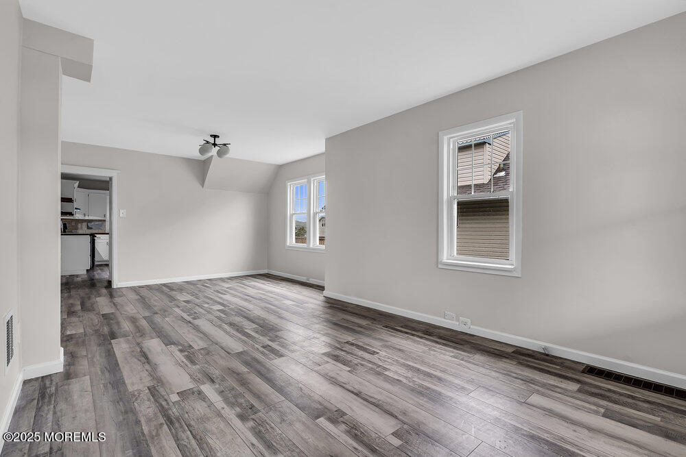 37 Knight Avenue Runnemede, NJ 08078 - Photo 23 of 50 a view of an empty room with a window and wooden floor