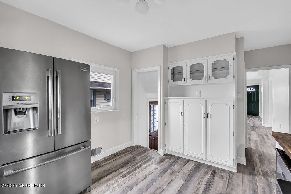 37 Knight Avenue Runnemede, NJ 08078 - Photo 34 of 50 a view of a refrigerator in kitchen and an empty room with wooden floor