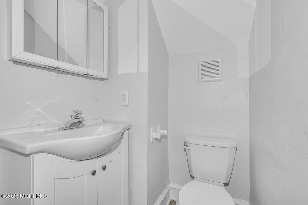 37 Knight Avenue Runnemede, NJ 08078 - Photo 41 of 50 a bathroom with a toilet sink and mirror