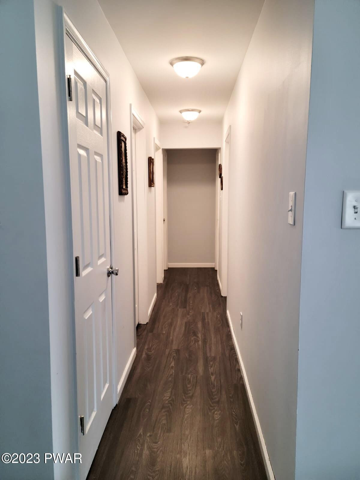 146 Roundhill Road Dingmans Ferry, PA 18328 - Photo 22 of 53 a view of a hallway with wooden floor and staircase