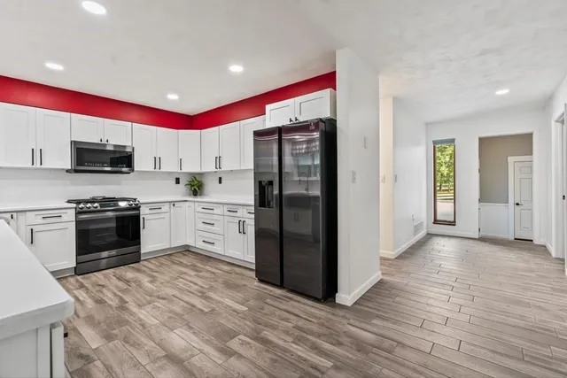 a kitchen with stainless steel appliances a stove sink and refrigerator