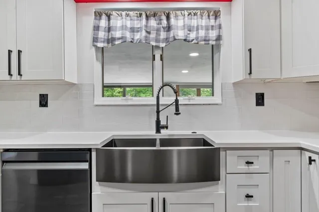 a kitchen with a sink and cabinets