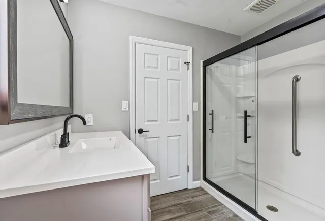a bathroom with a sink and mirror