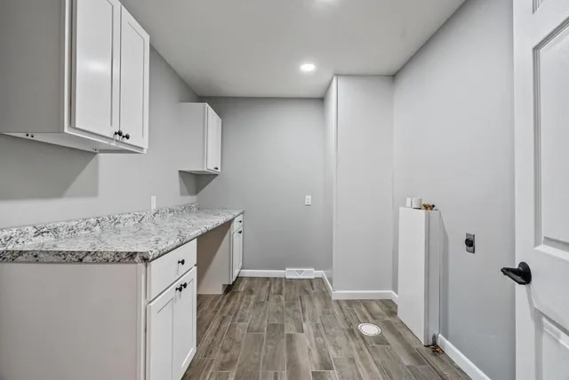 a kitchen with granite countertop a sink and cabinets