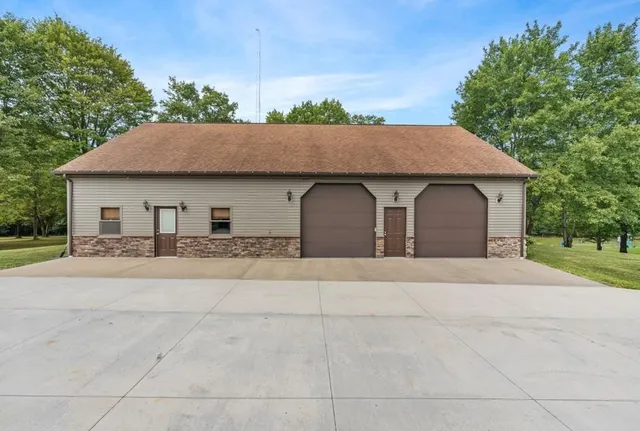 a front view of a house with a yard and trees