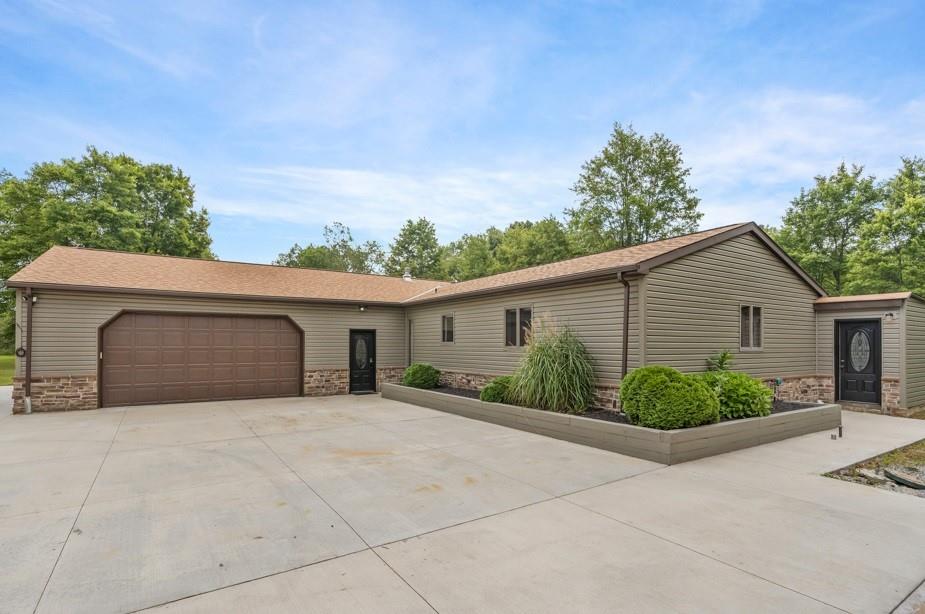 128 McGinley Road Chicora, PA 16025 - Photo 3 of 36 a view of a house with garage and potted plants