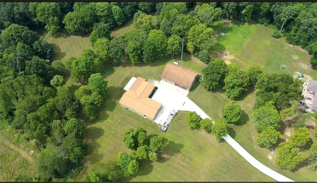 an aerial view of a house with a yard