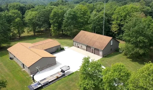 an aerial view of a house with pool garden and furniture
