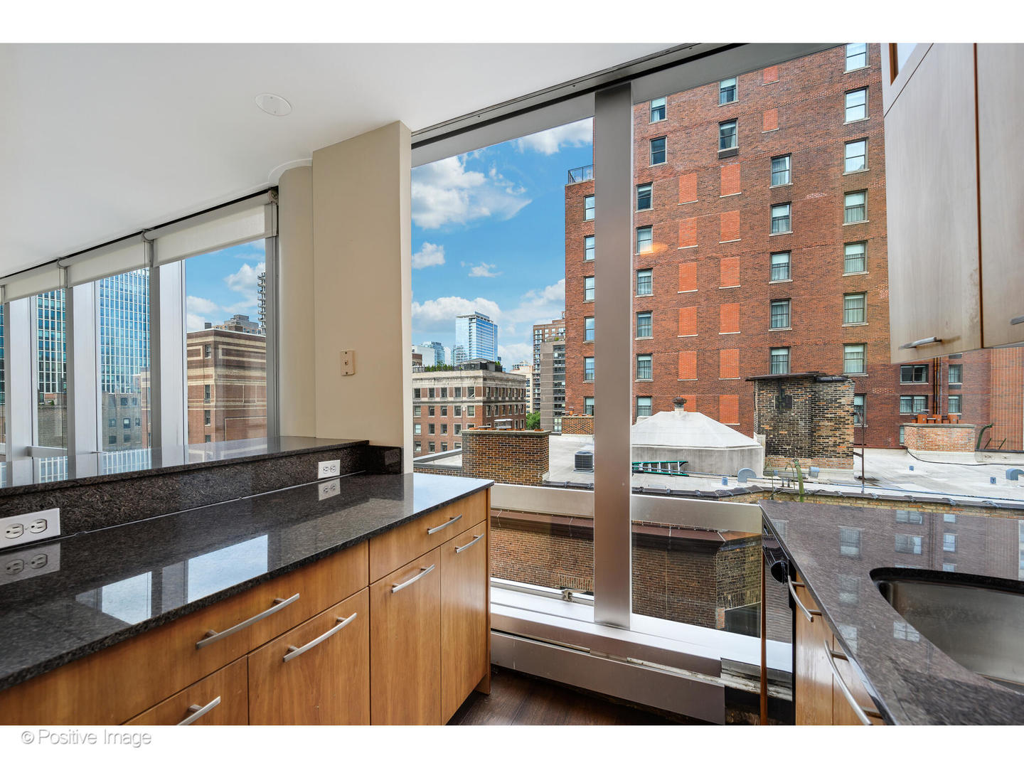1300 North Astor Street, Unit 10D Chicago, IL 60610 - Photo 11 of 25 a kitchen with granite countertop a sink and a stove