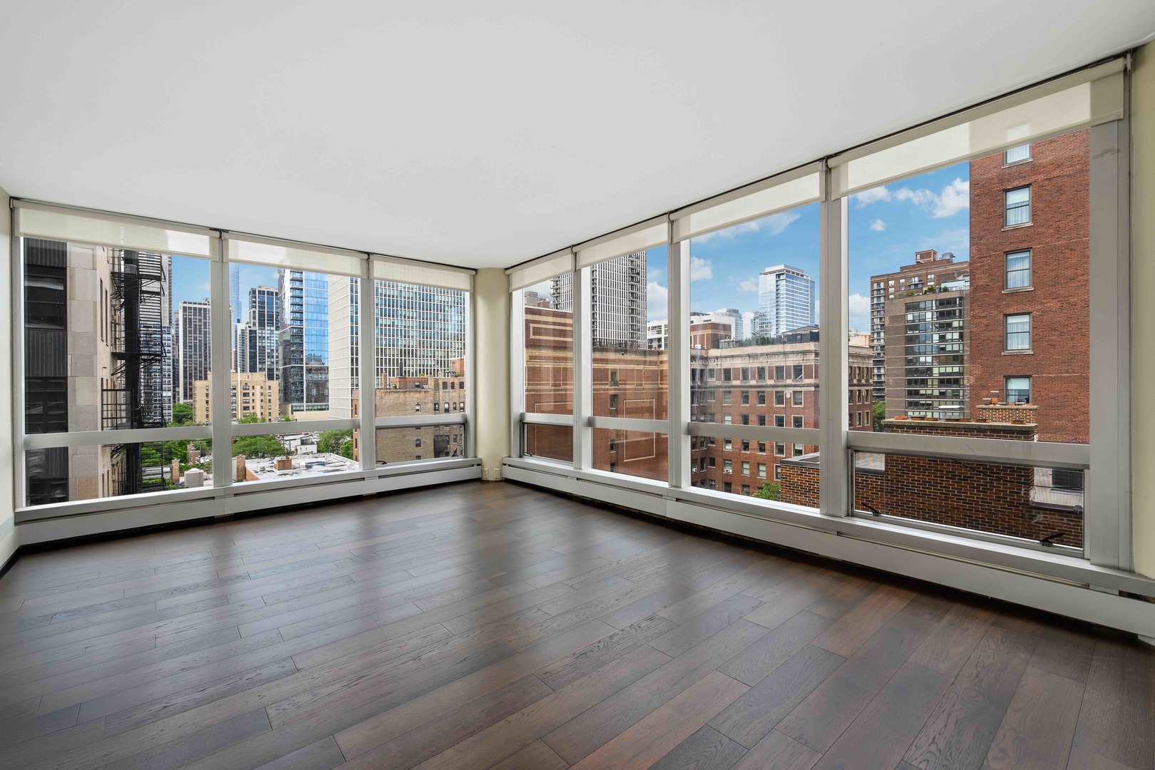 1300 North Astor Street, Unit 10D Chicago, IL 60610 - Photo 2 of 25 a view of room with wooden floor and floor to ceiling window