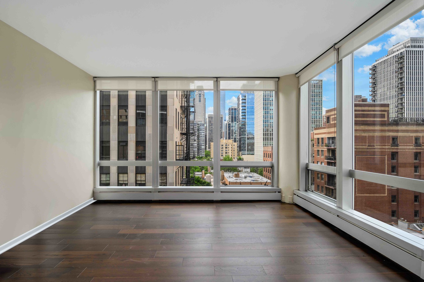 1300 North Astor Street, Unit 10D Chicago, IL 60610 - Photo 7 of 25 a view of an empty room with wooden floor and a window
