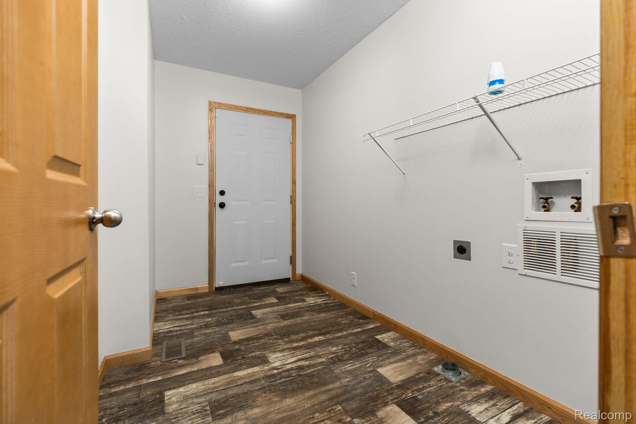 102 Wiard Road Ypsilanti, MI 48198 - Photo 27 of 37 Laundry room featuring electric dryer hookup, dark wood finished floors, a textured ceiling, and hookup for a washing machine