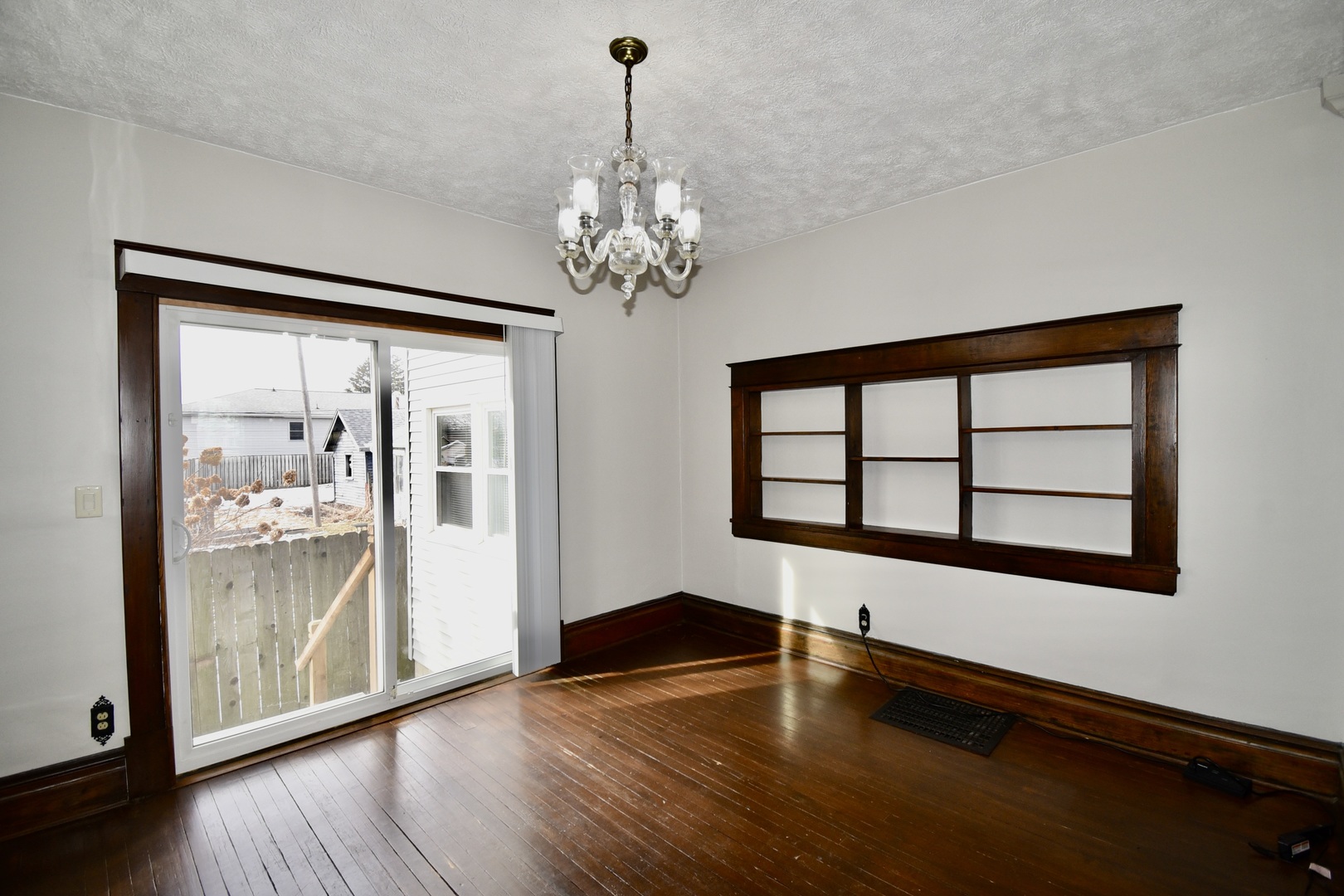 203 South Denver Street Bloomington, IL 61701 - Photo 13 of 54 a view of an empty room with wooden floor and a window