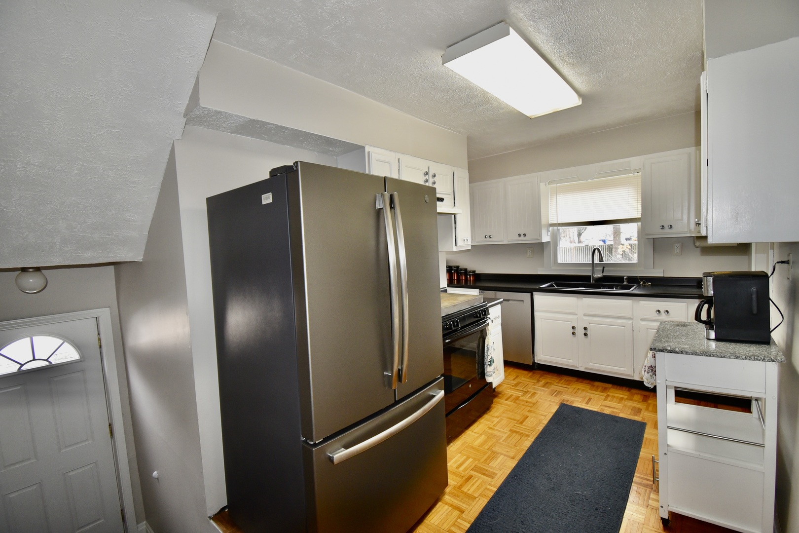 203 South Denver Street Bloomington, IL 61701 - Photo 16 of 54 a kitchen with stainless steel appliances granite countertop a refrigerator a sink and white cabinets