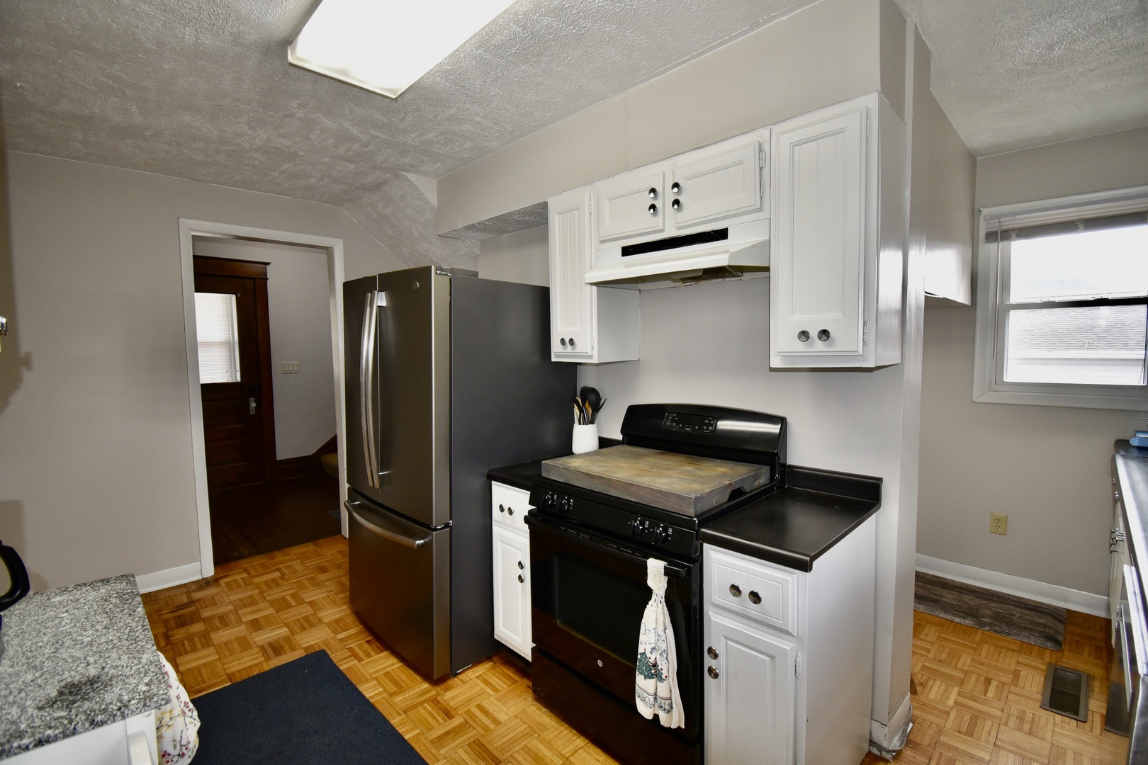 203 South Denver Street Bloomington, IL 61701 - Photo 18 of 54 a kitchen with stainless steel appliances granite countertop a refrigerator stove and sink