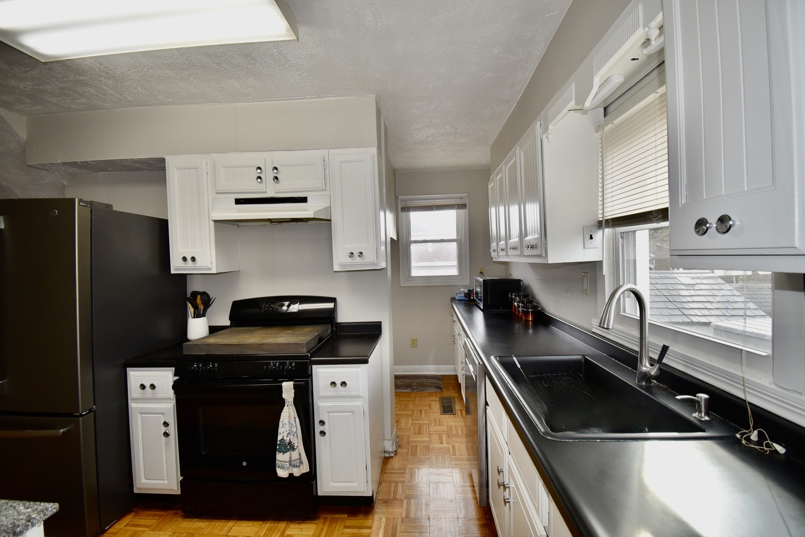 203 South Denver Street Bloomington, IL 61701 - Photo 20 of 54 a kitchen with granite countertop stainless steel appliances a sink stove and refrigerator