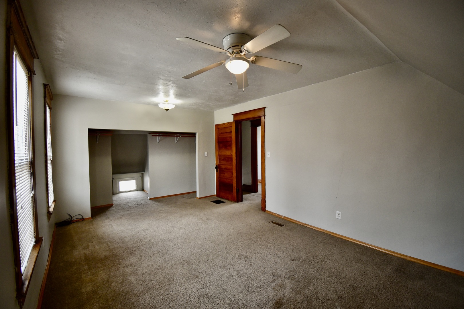 203 South Denver Street Bloomington, IL 61701 - Photo 38 of 54 an empty room with closet and a ceiling fan