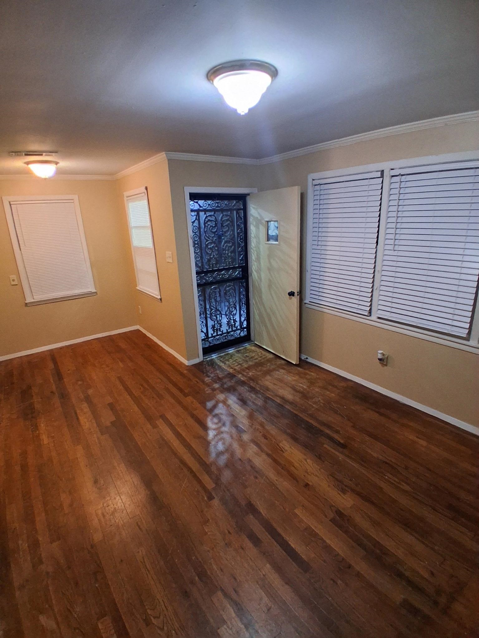 2435 Silver Street Memphis, TN 38106 - Photo 2 of 9 Unfurnished room with dark wood finished floors and crown molding