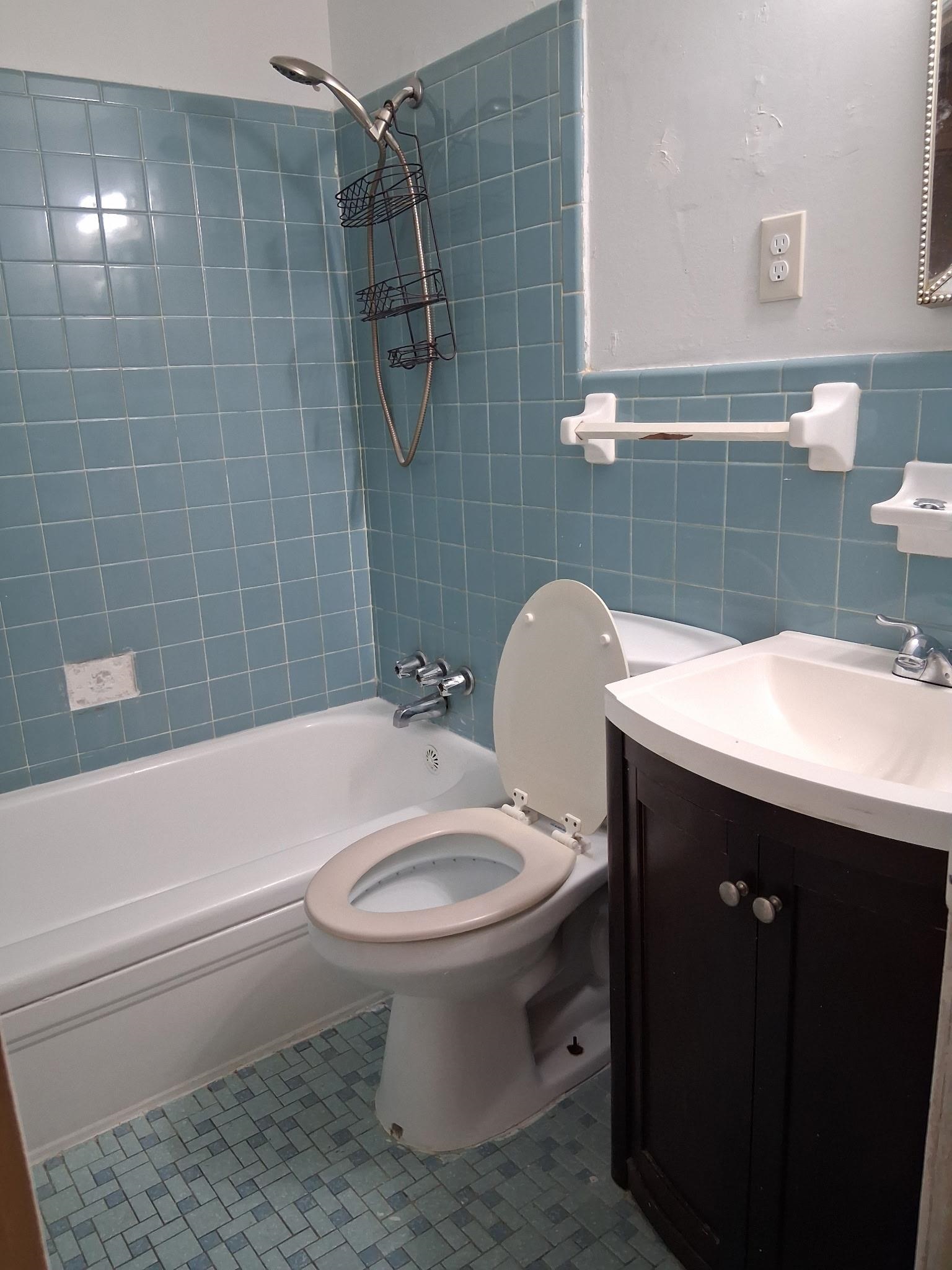 2435 Silver Street Memphis, TN 38106 - Photo 9 of 9 Bathroom with shower / bath combination, vanity, tile walls, tile patterned flooring, and wainscoting
