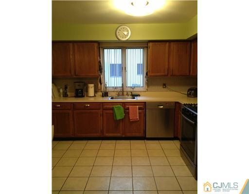 153 Redpine Loop Old Bridge, NJ 08857 - Photo 11 of 25 a kitchen with a sink a stove cabinets and a window