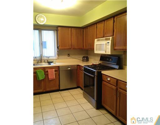 153 Redpine Loop Old Bridge, NJ 08857 - Photo 12 of 25 a kitchen with a sink a stove cabinets and a window