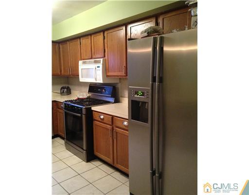 153 Redpine Loop Old Bridge, NJ 08857 - Photo 13 of 25 a kitchen with stainless steel appliances granite countertop a refrigerator and a sink