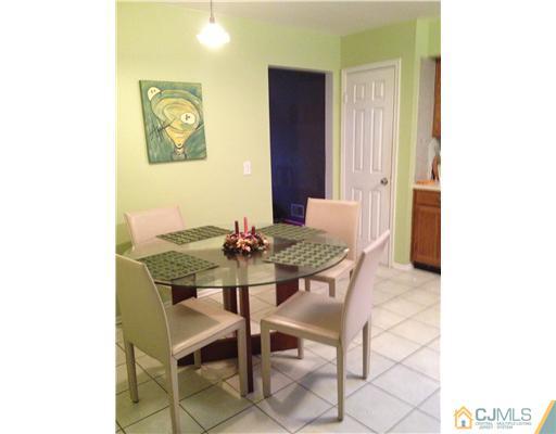 153 Redpine Loop Old Bridge, NJ 08857 - Photo 14 of 25 a view of a dining room with furniture and a potted plant