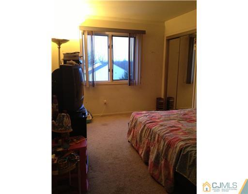 153 Redpine Loop Old Bridge, NJ 08857 - Photo 18 of 25 a bedroom with a bed and window