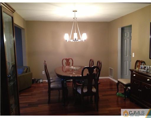 153 Redpine Loop Old Bridge, NJ 08857 - Photo 9 of 25 a view of a dining room with furniture and wooden floor