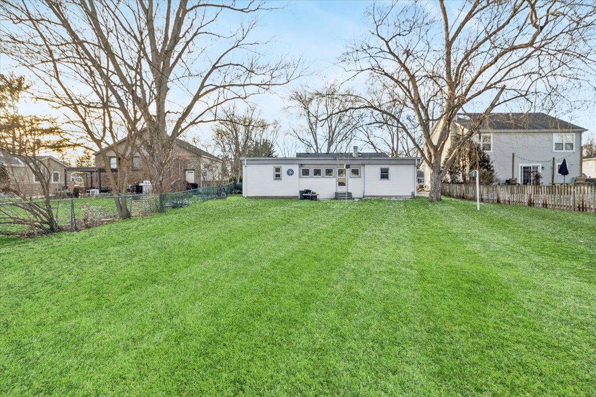 1034 South Harrison Street Batavia, IL 60510 - Photo 5 of 5 a white house that has a tree in front of it