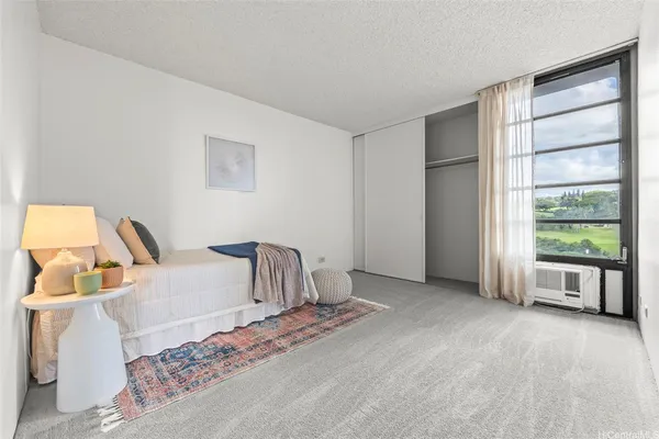 a bedroom with a bed and a large window