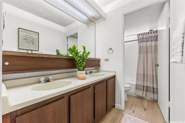 a bathroom with a sink a toilet and a mirror