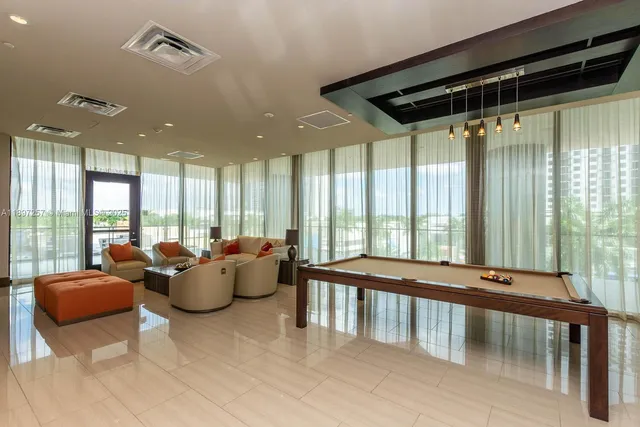 a living room with furniture and large windows