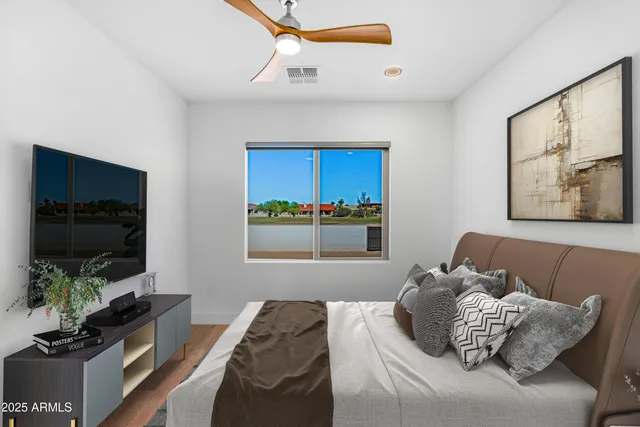 a dining hall with stainless steel appliances granite countertop a table chairs and a refrigerator