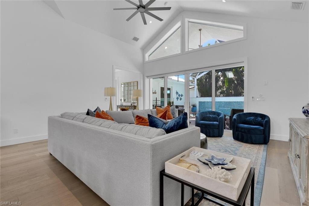 2130 Curtis Street Naples, FL 34112 - Photo 11 of 31 a living room with furniture and a chandelier