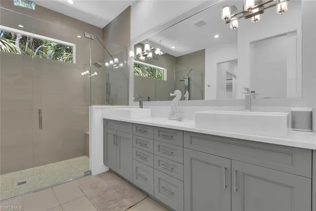 a bedroom with a large bed a chandelier and closet