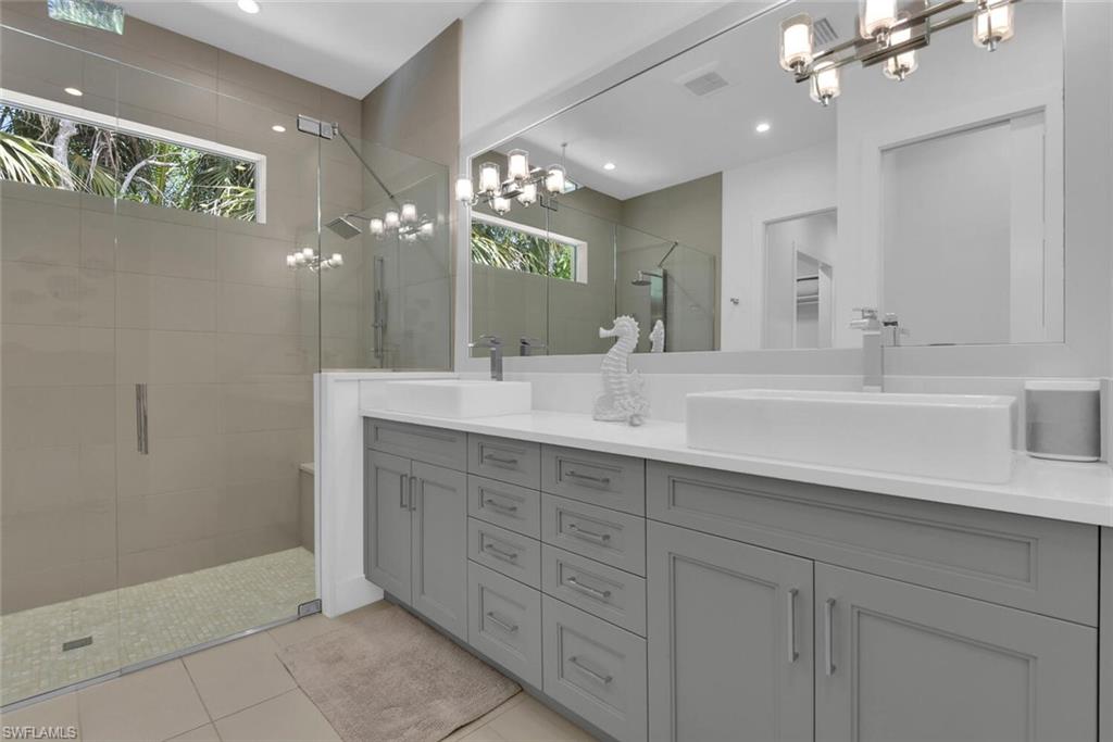 2130 Curtis Street Naples, FL 34112 - Photo 15 of 31 a bathroom with double sink and a mirror