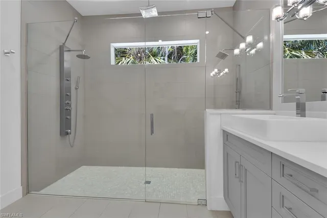 a bathroom with double sink and a mirror
