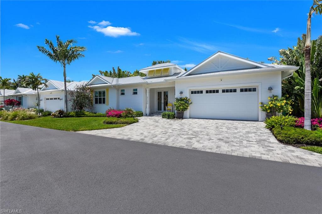 2130 Curtis Street Naples, FL 34112 - Photo 2 of 31 a front view of a house with a yard and a garage