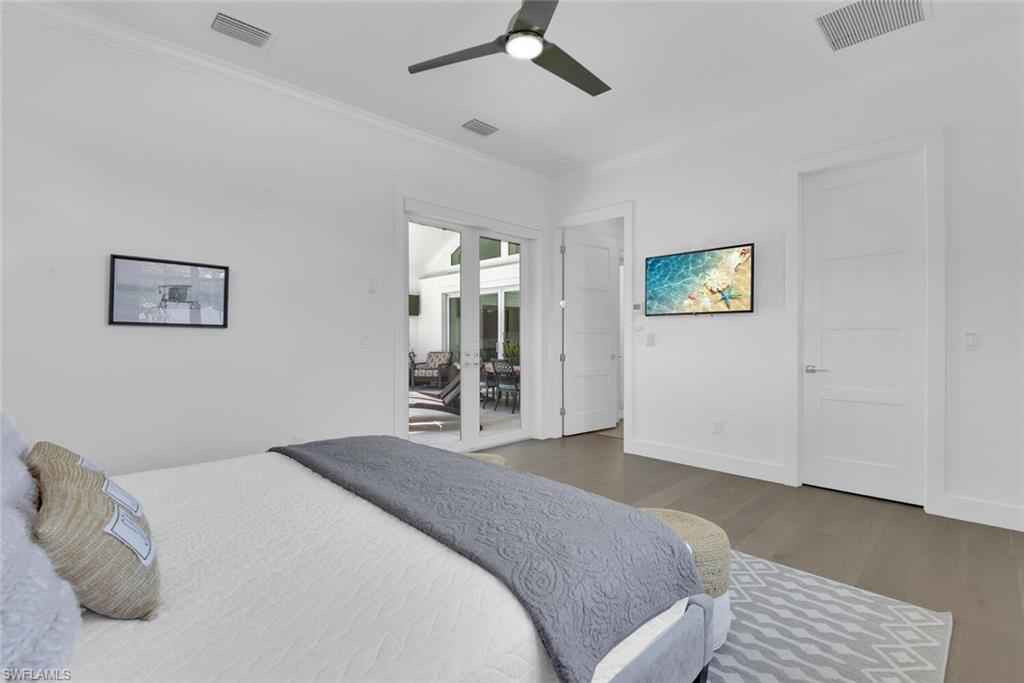 2130 Curtis Street Naples, FL 34112 - Photo 19 of 31 a bedroom with a bed and a chandelier