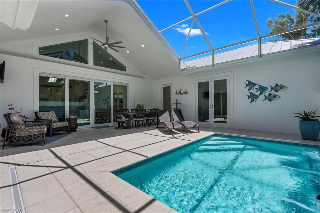 2130 Curtis Street Naples, FL 34112 - Photo 26 of 31 a view of a patio with table and chairs under an umbrella
