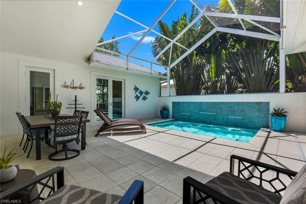 2130 Curtis Street Naples, FL 34112 - Photo 27 of 31 a patio with a table and chairs