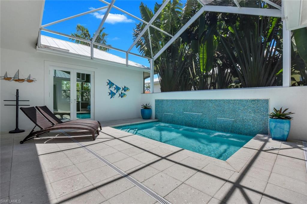 2130 Curtis Street Naples, FL 34112 - Photo 28 of 31 a view of a chairs and tables in the back yard of the house