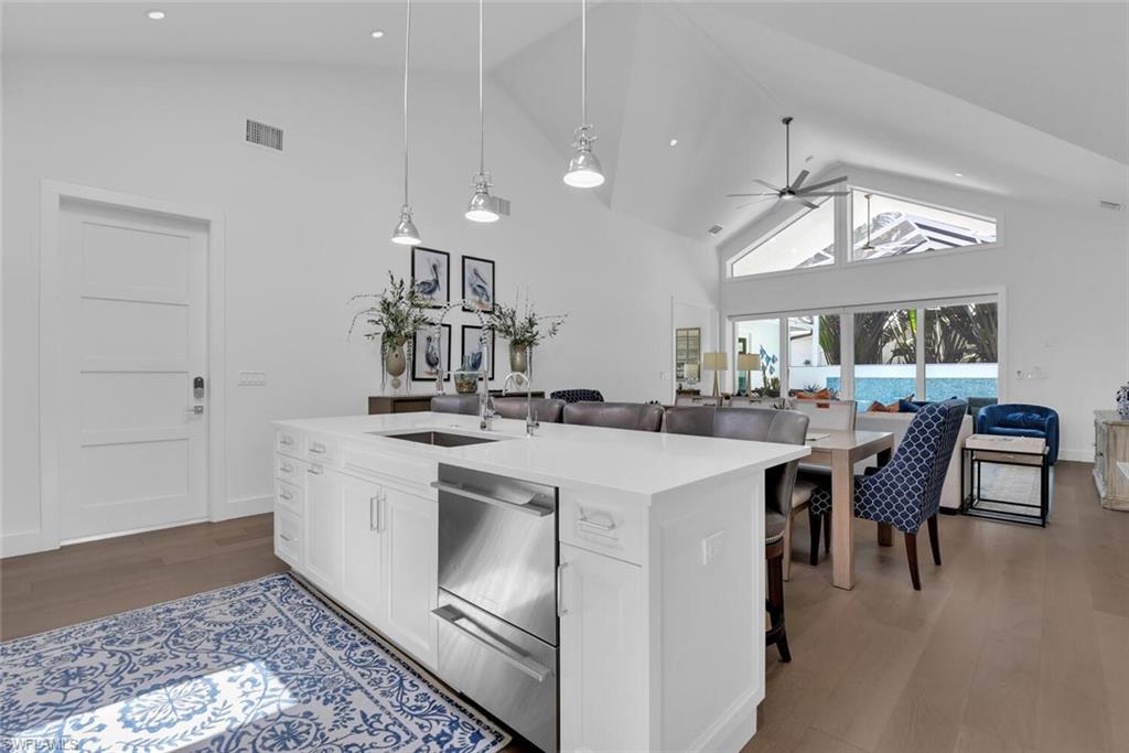 2130 Curtis Street Naples, FL 34112 - Photo 31 of 31 a kitchen with a sink a stove a dining table and chairs