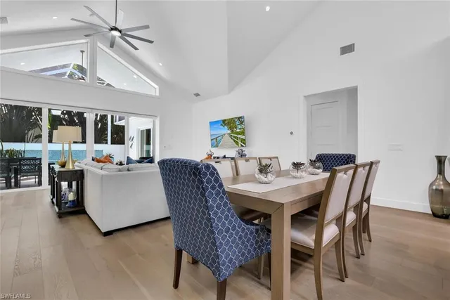 a kitchen with a sink a stove a dining table and chairs