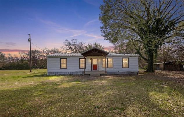 11867 Cherokee Way Lindale, TX 75771 - Photo 1 of 1 a view of a yard in front of a house with large trees
